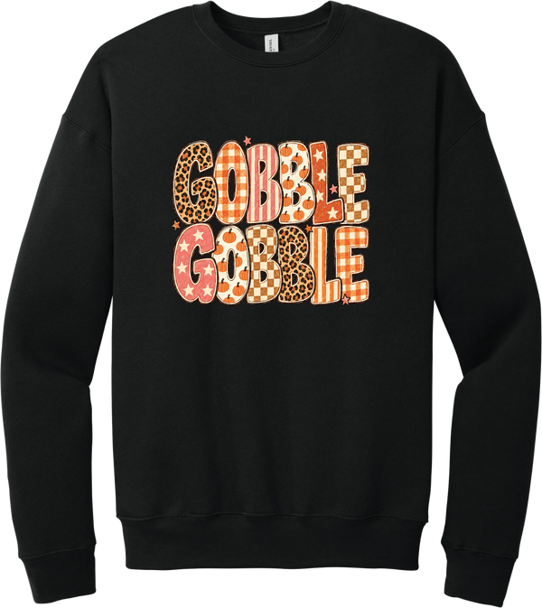 Gobble Gobble Patchwork crewneck sweatshirt in Black, featuring Gobble Gobble in bubble letters filled with leopard, gingham, checkerboard, stars, and pumpkin prints