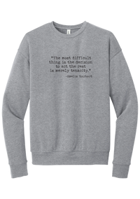 Amelia Earhart Tenacity Quote crewneck sweatshirt in Athletic Heather, featuring The most difficult thing is the decision to act the rest is merely tenacity in distressed black typewriter letters