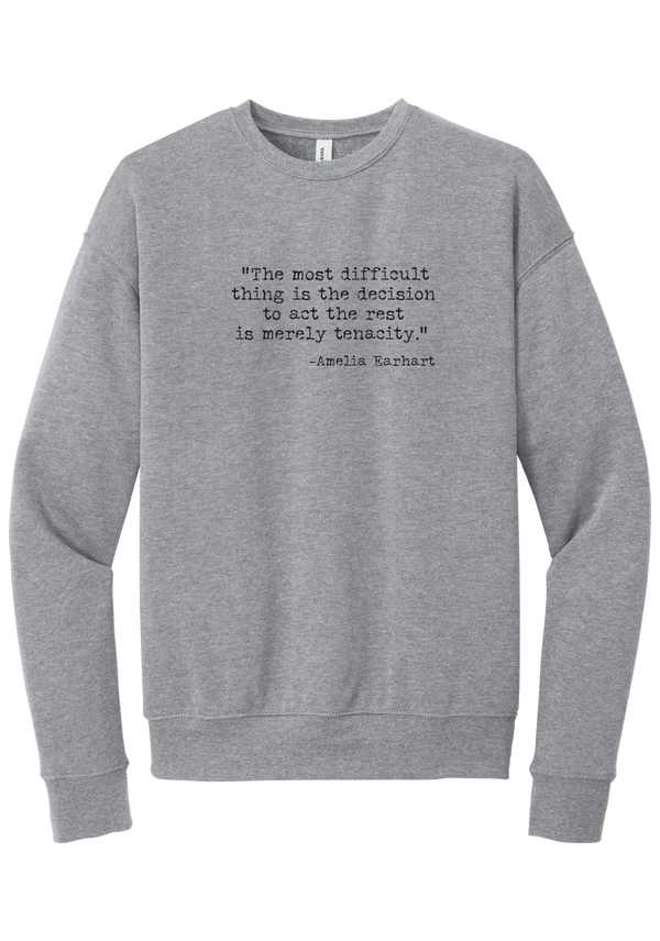 Amelia Earhart Tenacity Quote crewneck sweatshirt in Athletic Heather, featuring The most difficult thing is the decision to act the rest is merely tenacity in distressed black typewriter letters