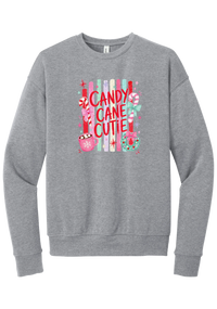 Candy Cane Cutie crewneck sweatshirt in Athletic Heather, featuring red CANDY CANE CUTIE letters on pastel stripes with candy canes, cocoa, and bows