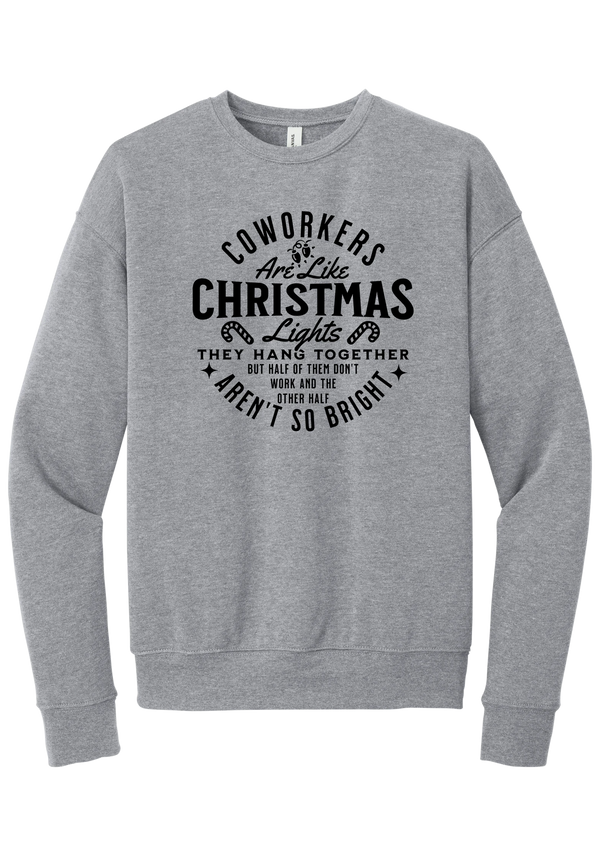 Coworkers Are Like Christmas Lights crewneck sweatshirt in Athletic Heather, featuring bold black type reading Coworkers Are Like Christmas Lights, they hang together but half of them don't work and the other half aren't so bright