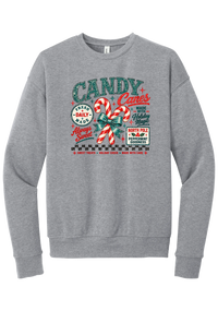 Fresh Candy Canes crewneck sweatshirt in Athletic Heather, featuring vintage candy shop lettering with two striped candy canes tied in a green bow, a North Pole Peppermint Goodness sign, and a checkerboard stripe
