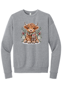 Highland Holidays crewneck sweatshirt in Athletic Heather, featuring a fluffy baby Highland cow in a Fair Isle knit scarf, surrounded by frosted eucalyptus, pine, red berries, and white Christmas roses