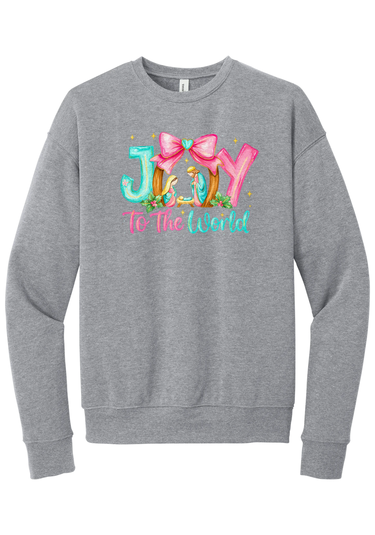 Joy to the World Nativity crewneck sweatshirt in Athletic Heather, featuring painted JOY letters framing a nativity scene with a pink bow and To The World script