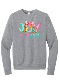 Joy to the World Nativity crewneck sweatshirt in Athletic Heather, featuring painted JOY letters framing a nativity scene with a pink bow and To The World script
