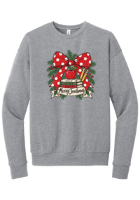 Merry Teachmas crewneck sweatshirt in Athletic Heather, featuring a red polka dot bow over a stack of books reading Teach, Inspire, Change with an apple, pencils, evergreen, and a Merry Teachmas banner