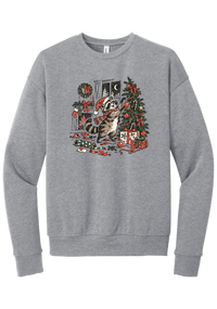 Raccoon Christmas crewneck sweatshirt in Athletic Heather, featuring a vintage-style raccoon in a Santa hat and plaid scarf decorating a Christmas tree by the fireplace with ribbon and gifts scattered around