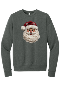 Crocheted Santa crewneck sweatshirt in Deep Heather, featuring a yarn-textured Santa face with a chunky cream beard, round glasses, and a red knit hat with snowflakes and a pom-pom