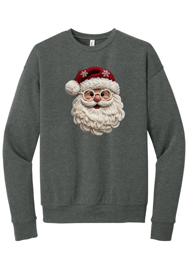 Crocheted Santa crewneck sweatshirt in Deep Heather, featuring a yarn-textured Santa face with a chunky cream beard, round glasses, and a red knit hat with snowflakes and a pom-pom