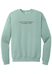 I Don't Hold Grudges crewneck sweatshirt in Dusty Blue, featuring I don't hold grudges, I remember facts in distressed black typewriter letters