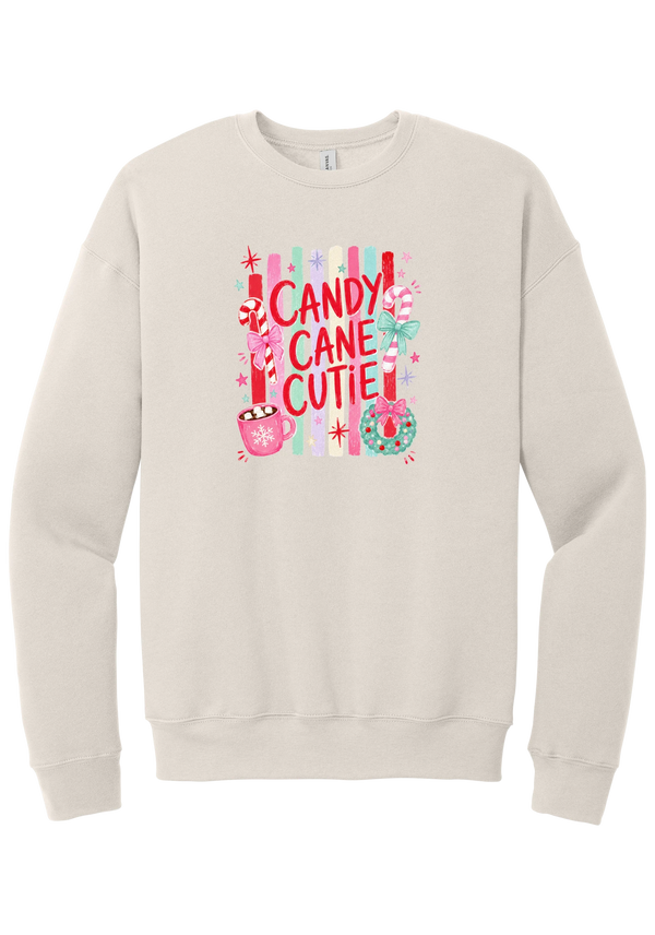 Candy Cane Cutie crewneck sweatshirt in Heather Dust, featuring red CANDY CANE CUTIE letters on pastel stripes with candy canes, cocoa, and bows