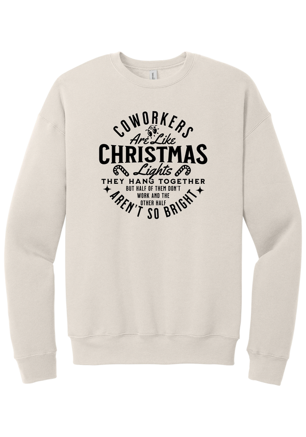 Coworkers Are Like Christmas Lights crewneck sweatshirt in Heather Dust, featuring bold black type reading Coworkers Are Like Christmas Lights, they hang together but half of them don't work and the other half aren't so bright