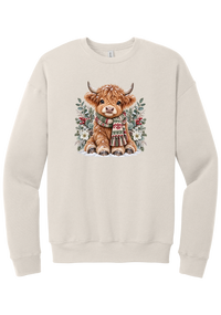 Highland Holidays crewneck sweatshirt in Heather Dust, featuring a fluffy baby Highland cow in a Fair Isle knit scarf, surrounded by frosted eucalyptus, pine, red berries, and white Christmas roses