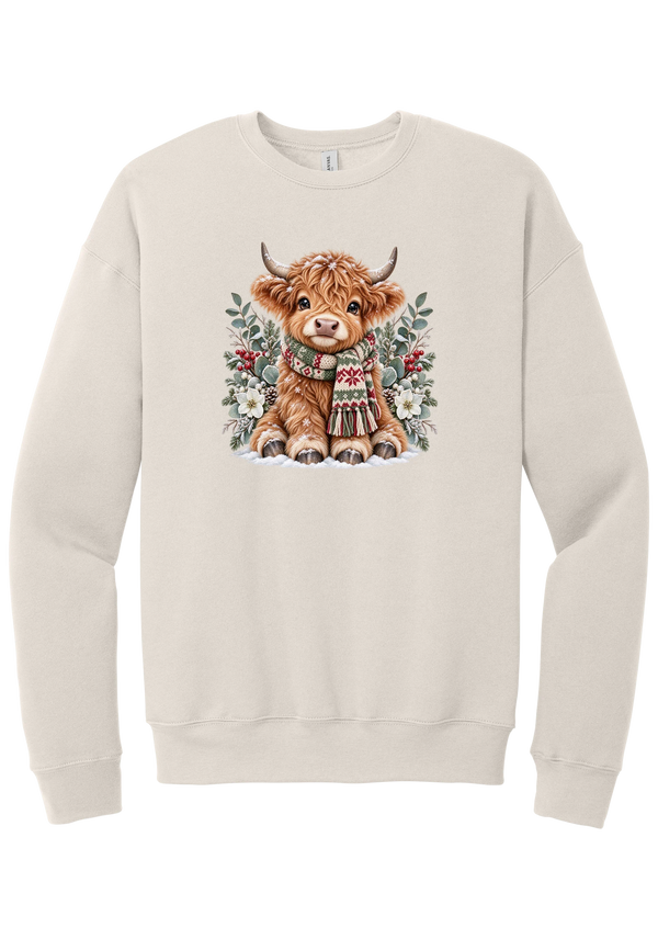 Highland Holidays crewneck sweatshirt in Heather Dust, featuring a fluffy baby Highland cow in a Fair Isle knit scarf, surrounded by frosted eucalyptus, pine, red berries, and white Christmas roses