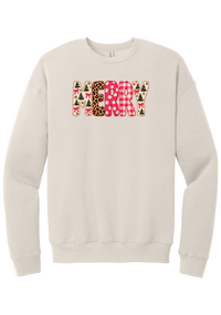 Merry Preppy Applique crewneck sweatshirt in Heather Dust, featuring faux applique MERRY letters in pink and green patchwork patterns with trees, gingham, Santas, polka dots, and candy cane stripes