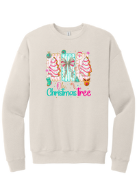 Oh Christmas Tree Cakes crewneck sweatshirt in Heather Dust, featuring frosted Christmas tree snack cakes on pink and mint panels over Oh Christmas Tree lettering