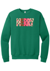 Merry Preppy Applique crewneck sweatshirt in Kelly Green, featuring faux applique MERRY letters in pink and green patchwork patterns with trees, gingham, Santas, polka dots, and candy cane stripes