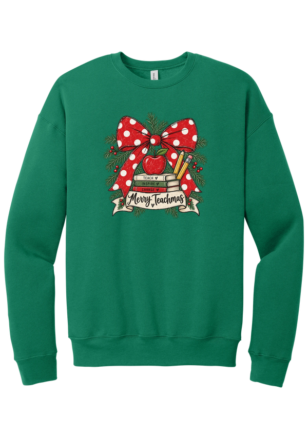 Merry Teachmas crewneck sweatshirt in Kelly Green, featuring a red polka dot bow over a stack of books reading Teach, Inspire, Change with an apple, pencils, evergreen, and a Merry Teachmas banner