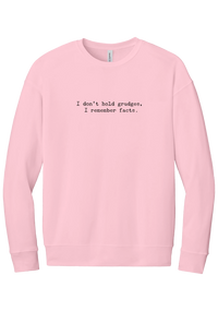 I Don't Hold Grudges crewneck sweatshirt in Pink, featuring I don't hold grudges, I remember facts in distressed black typewriter letters