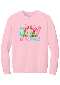 Joy to the World Nativity crewneck sweatshirt in Pink, featuring painted JOY letters framing a nativity scene with a pink bow and To The World script