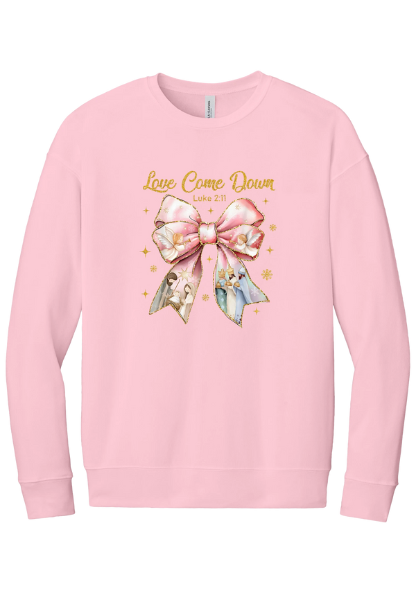 Love Came Down Nativity Bow crewneck sweatshirt in Pink, featuring a blush satin bow with painted nativity scenes under gold Love Came Down script and Luke 2:11
