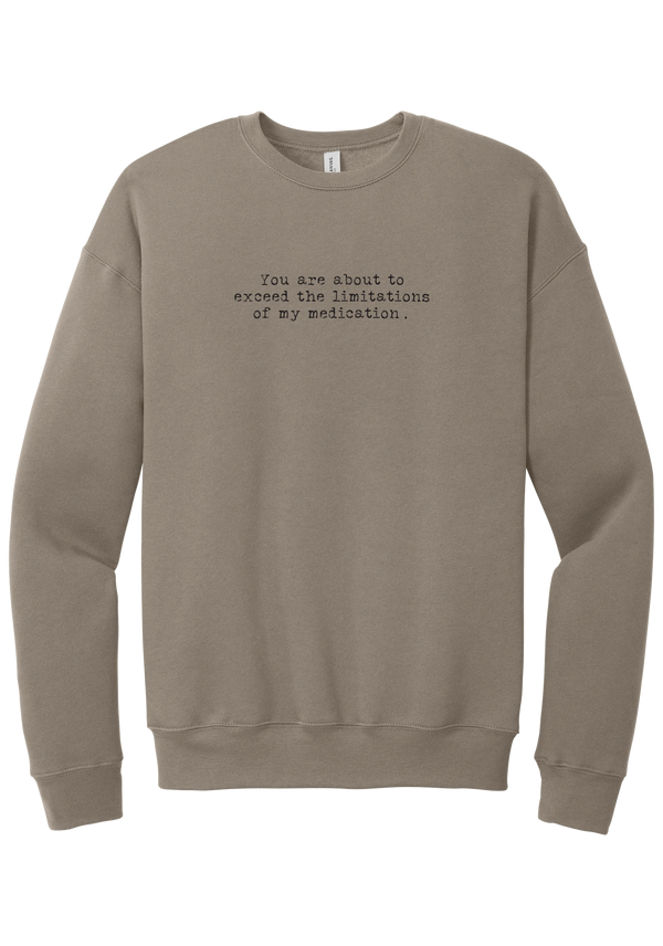 Limitations of My Medication crewneck sweatshirt in Tan, featuring You are about to exceed the limitations of my medication in distressed black typewriter letters