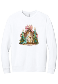 Painterly Nativity crewneck sweatshirt in White, featuring a painterly nativity scene with Mary, Joseph, and baby Jesus in a wooden stable between teal Christmas trees and a pink bow