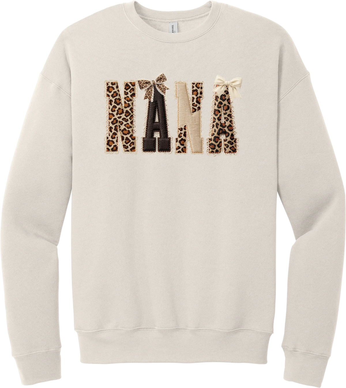Grandma Leopard Applique crewneck sweatshirt in Heather Dust, featuring NANA spelled out in leopard, cream, and chocolate patches with a scalloped stitched applique look and two bows