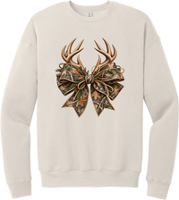 Coquette Antlers crewneck sweatshirt in Heather Dust, featuring deer antlers tied with an oversized camo bow, twine, and autumn leaves