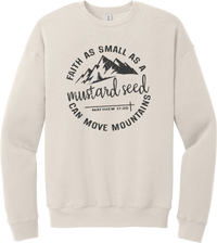 Mustard Seed Faith crewneck sweatshirt in Heather Dust, featuring a circle badge of mountains and a cross with Faith as Small as a Mustard Seed Can Move Mountains lettering and Matthew 17:20