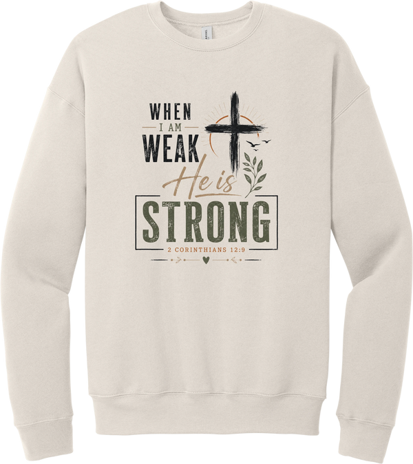 When I Am Weak crewneck sweatshirt in Heather Dust, featuring When I Am Weak He Is Strong lettering with a cross and 2 Corinthians 12:9