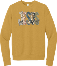 Jesus Patchwork crewneck sweatshirt in Heather Mustard, featuring JESUS in patchwork letters of floral, leopard, denim, and cow print with gingham bows and a heart
