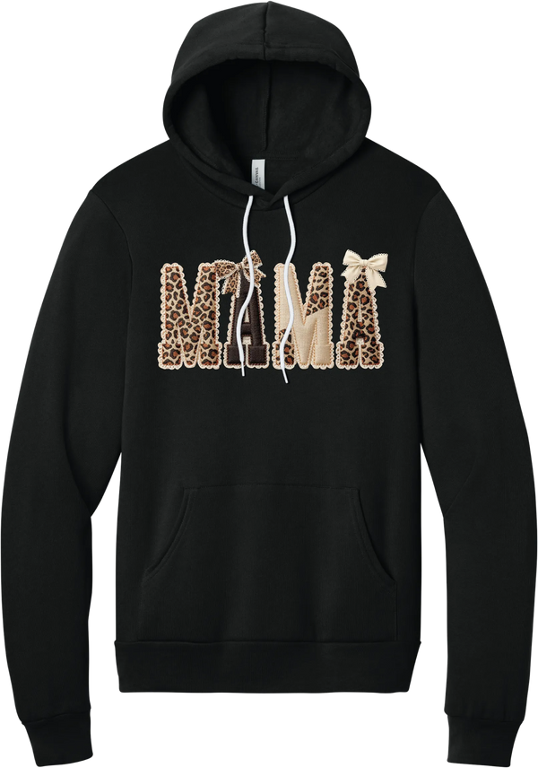 Mama Leopard Applique hoodie in Black, featuring MAMA spelled out in leopard, cream, and chocolate patches with a scalloped stitched applique look and two bows