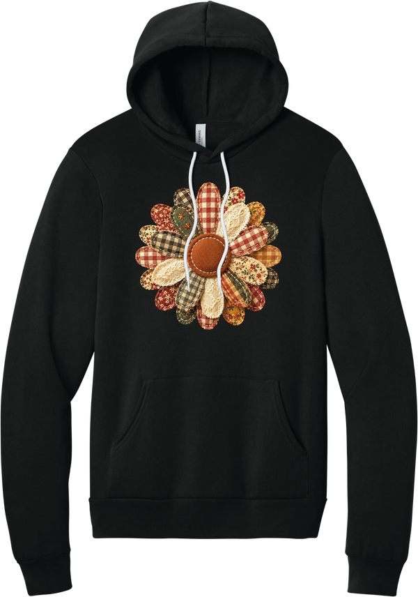 Patchwork Fabric Flower hoodie in Black, featuring an oversized fabric flower with plaid, gingham, calico, and cable knit petals around a stitched rust center