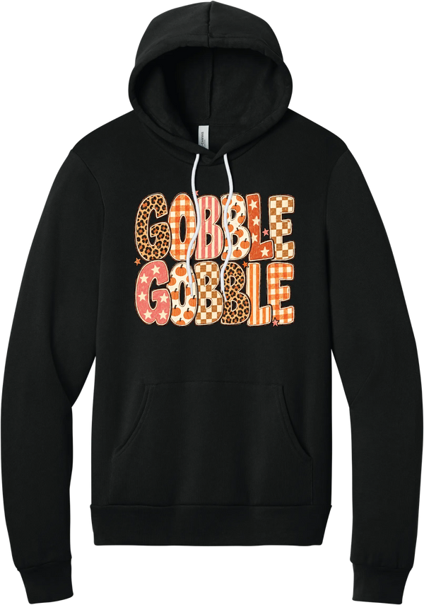 Gobble Gobble Patchwork hoodie in Black, featuring Gobble Gobble in bubble letters filled with leopard, gingham, checkerboard, stars, and pumpkin prints