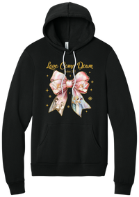 Love Came Down Nativity Bow hoodie in Black, featuring a blush satin bow with painted nativity scenes under gold Love Came Down script and Luke 2:11