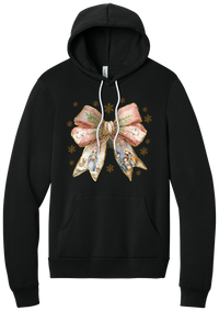 Nativity Bow hoodie in Black, featuring a blush satin bow with painted nativity scenes in its ribbons and gold snowflakes