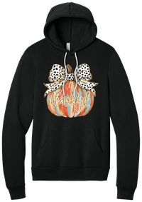 Thankful Pumpkin Bow hoodie in Black, featuring a painted pumpkin with a spotted bow and thankful in gold glitter script