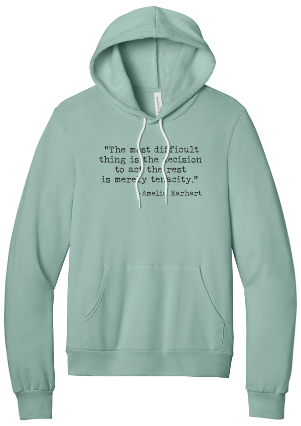 Amelia Earhart Tenacity Quote hoodie in Dusty Blue, featuring The most difficult thing is the decision to act the rest is merely tenacity in distressed black typewriter letters
