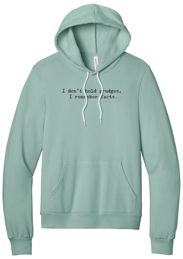 I Don't Hold Grudges hoodie in Dusty Blue, featuring I don't hold grudges, I remember facts in distressed black typewriter letters