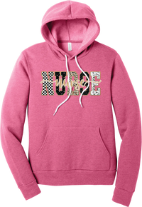 Glitzy Patterned Nurse hoodie in Heather Charity Pink, featuring NURSE block letters in checkerboard, leopard, and polka dot patterns with a gold glitter outline and nurse script