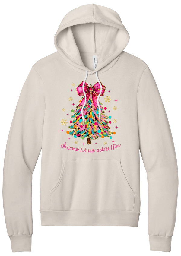 Adore Him Ribbon Tree hoodie in Heather Dust, featuring a colorful ribbon Christmas tree with a pink bow over Oh Come Let Us Adore Him script