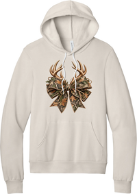 Coquette Antlers hoodie in Heather Dust, featuring deer antlers tied with an oversized camo bow, twine, and autumn leaves