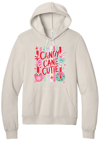 Candy Cane Cutie hoodie in Heather Dust, featuring red CANDY CANE CUTIE letters on pastel stripes with candy canes, cocoa, and bows