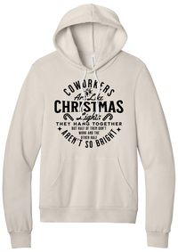 Coworkers Are Like Christmas Lights hoodie in Heather Dust, featuring bold black type reading Coworkers Are Like Christmas Lights, they hang together but half of them don't work and the other half aren't so bright