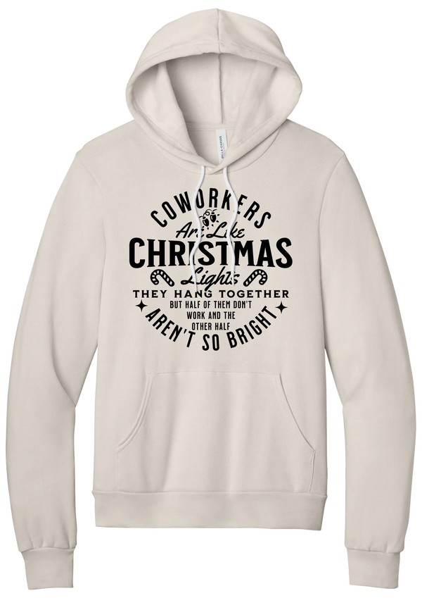 Coworkers Are Like Christmas Lights hoodie in Heather Dust, featuring bold black type reading Coworkers Are Like Christmas Lights, they hang together but half of them don't work and the other half aren't so bright