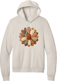 Patchwork Fabric Flower hoodie in Heather Dust, featuring an oversized fabric flower with plaid, gingham, calico, and cable knit petals around a stitched rust center
