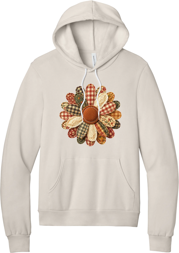 Patchwork Fabric Flower hoodie in Heather Dust, featuring an oversized fabric flower with plaid, gingham, calico, and cable knit petals around a stitched rust center
