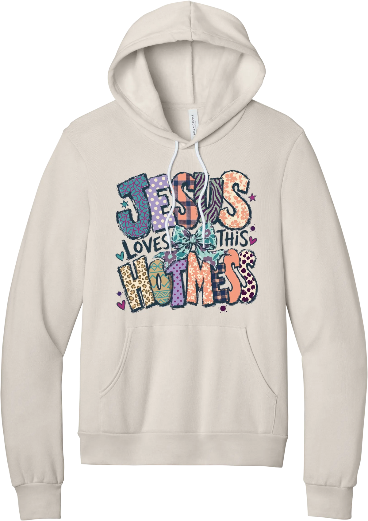 Jesus Loves This Hot Mess hoodie in Heather Dust, featuring patchwork Jesus Loves This Hot Mess lettering in leopard, plaid, polka dot, and zebra prints with a bow and hearts