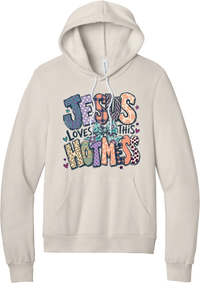 Jesus Loves This Hot Mess hoodie in Heather Dust, featuring patchwork Jesus Loves This Hot Mess lettering in leopard, plaid, polka dot, and zebra prints with a bow and hearts